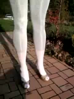 Encasement over shiny leggings and turtleneck white